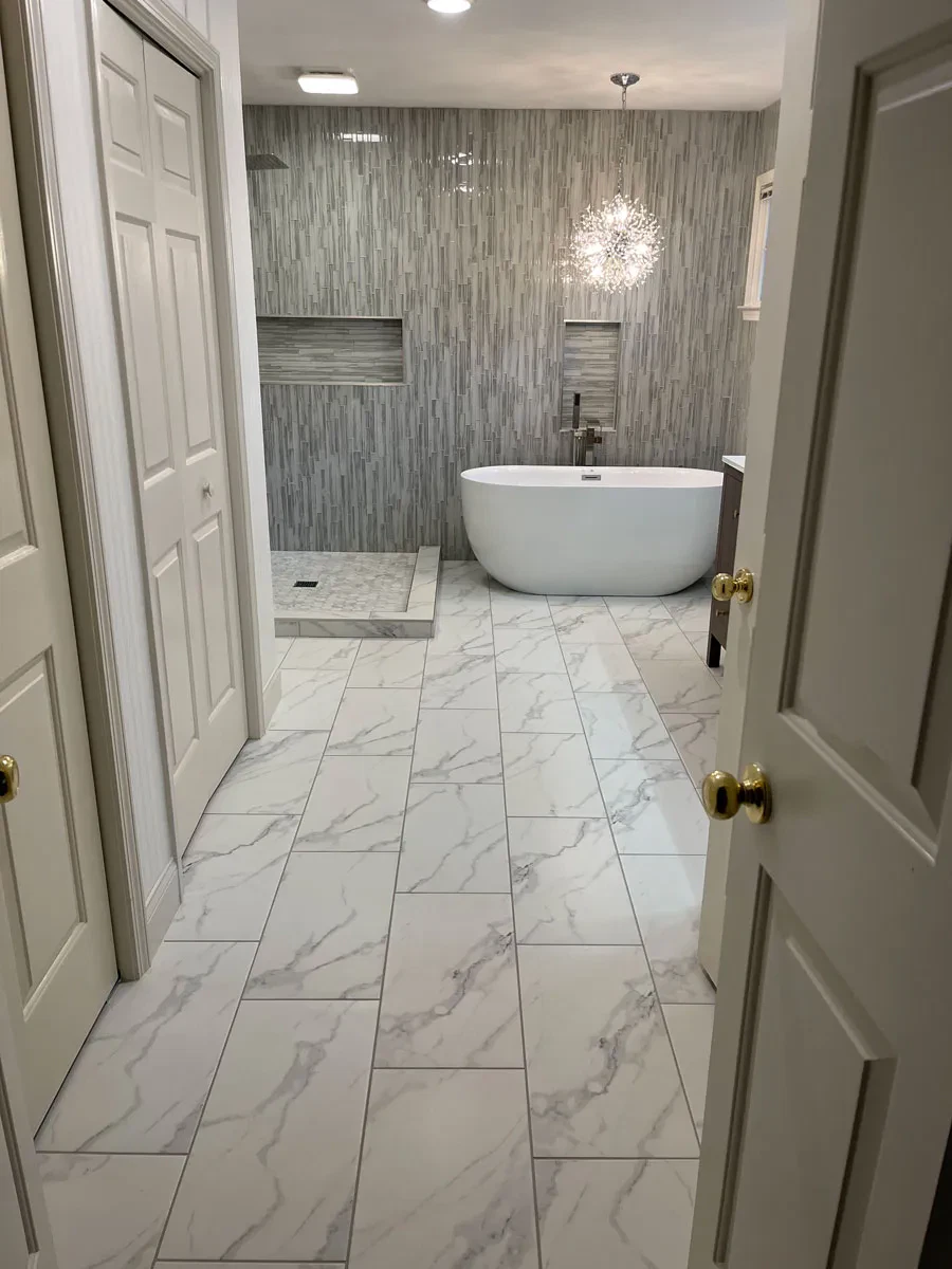 Elegant bathroom with freestanding tub and textured walls